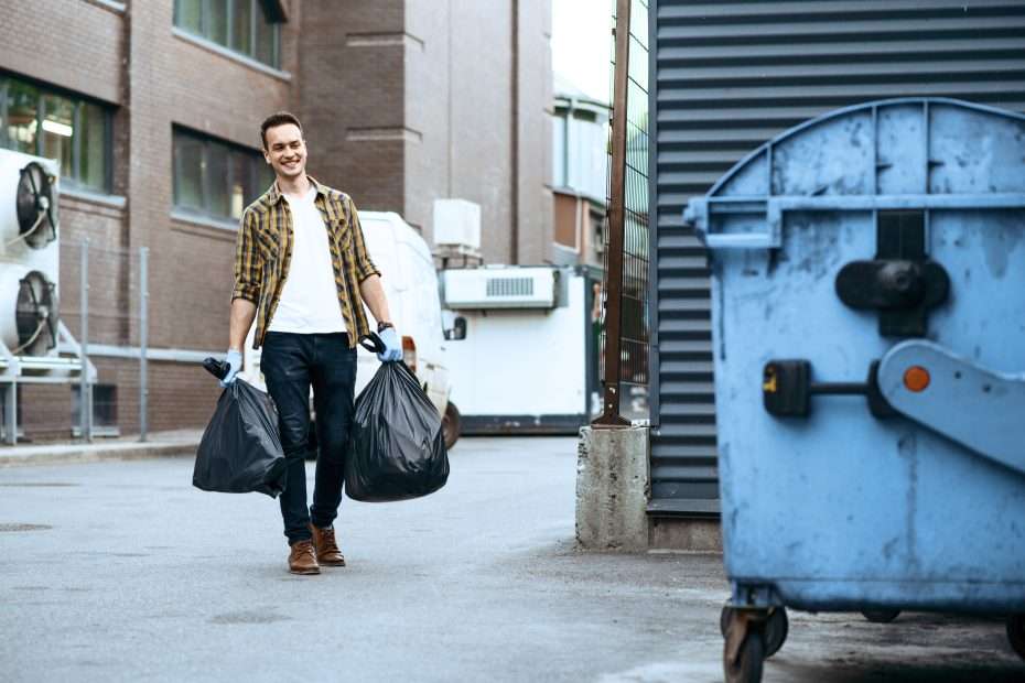 volunteer carries plastic trash bags to the can 2024 12 03 02 39 46 utc